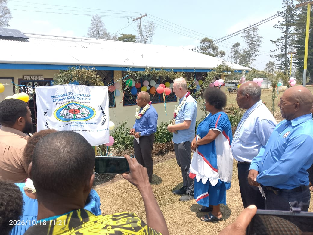 Church representatives and college community members gathered outside a decorated classroom at Lutheran Church College, Banz.